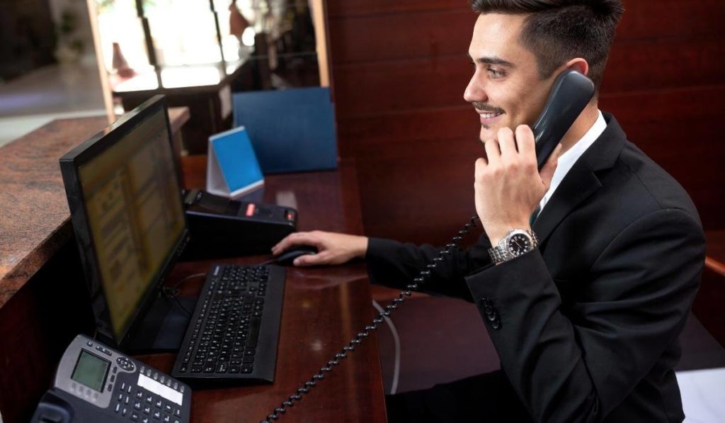 Employee answering call using a voip phone, device capable of using the voip technology for communications. 