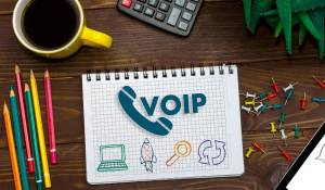 VoIP Examples and concept - voip written on a sheet of paper with tech icons