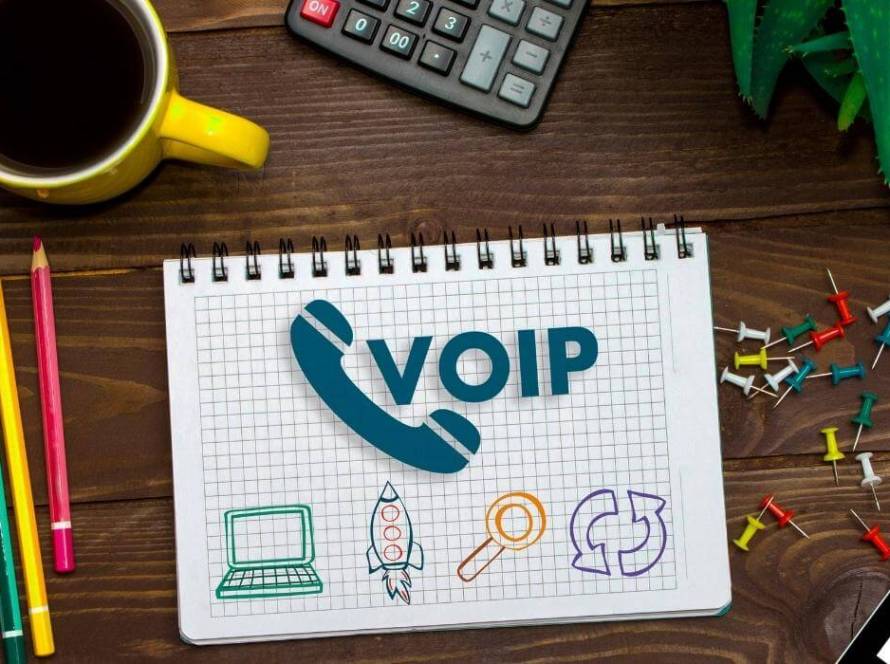 VoIP Examples and concept - voip written on a sheet of paper with tech icons