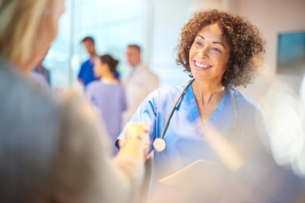 Outsourcing your medical billing - Featured Image_A female doctor welcomes a business partner