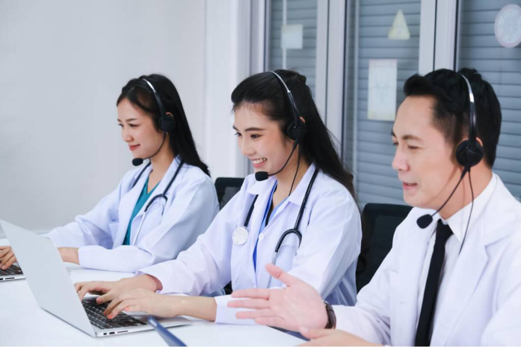 Medical outsourcing - team doctor and nurse working call center operator with headset in hospital or workplace