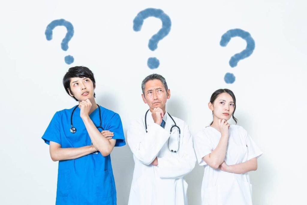 Medical staff thinking with big question mark drawn above their head. 
