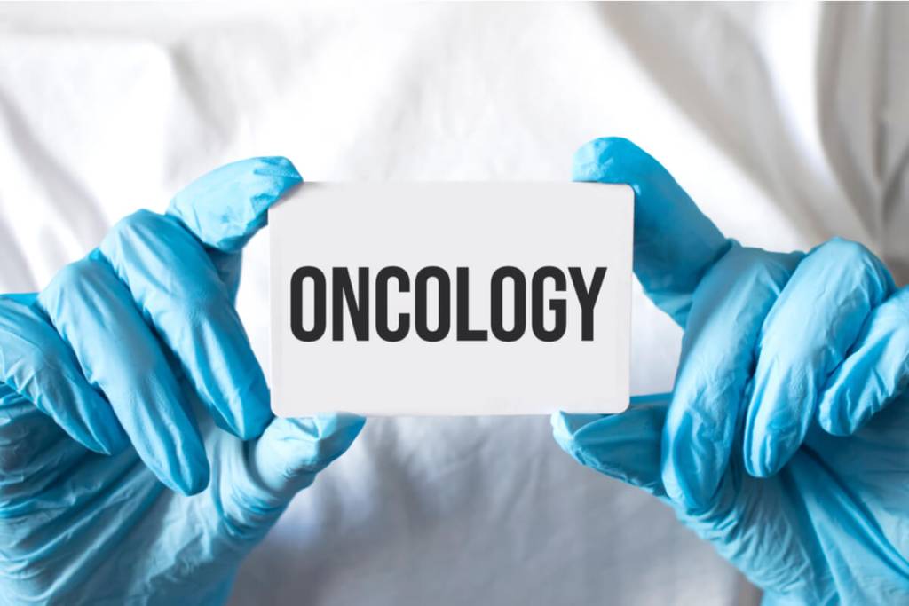 What Is Oncology Billing -Doctor holding a card with text Oncology, medical concept