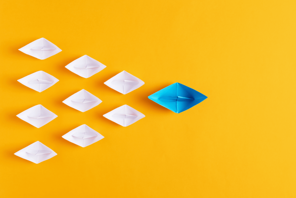 Business Process Outsourcing Solutions - Featured Image 2087076469 - Image of tiny paper boats with the blue boat acting as a guide