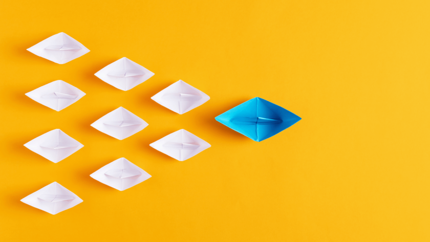 Business Process Outsourcing Solutions - Featured Image 2087076469 - Image of tiny paper boats with the blue boat acting as a guide