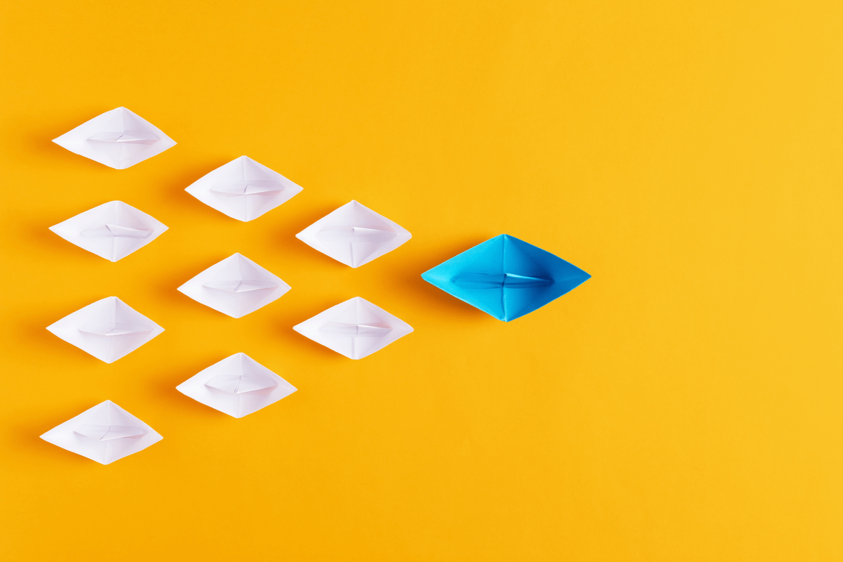 Business Process Outsourcing Solutions - Featured Image 2087076469 - Image of tiny paper boats with the blue boat acting as a guide