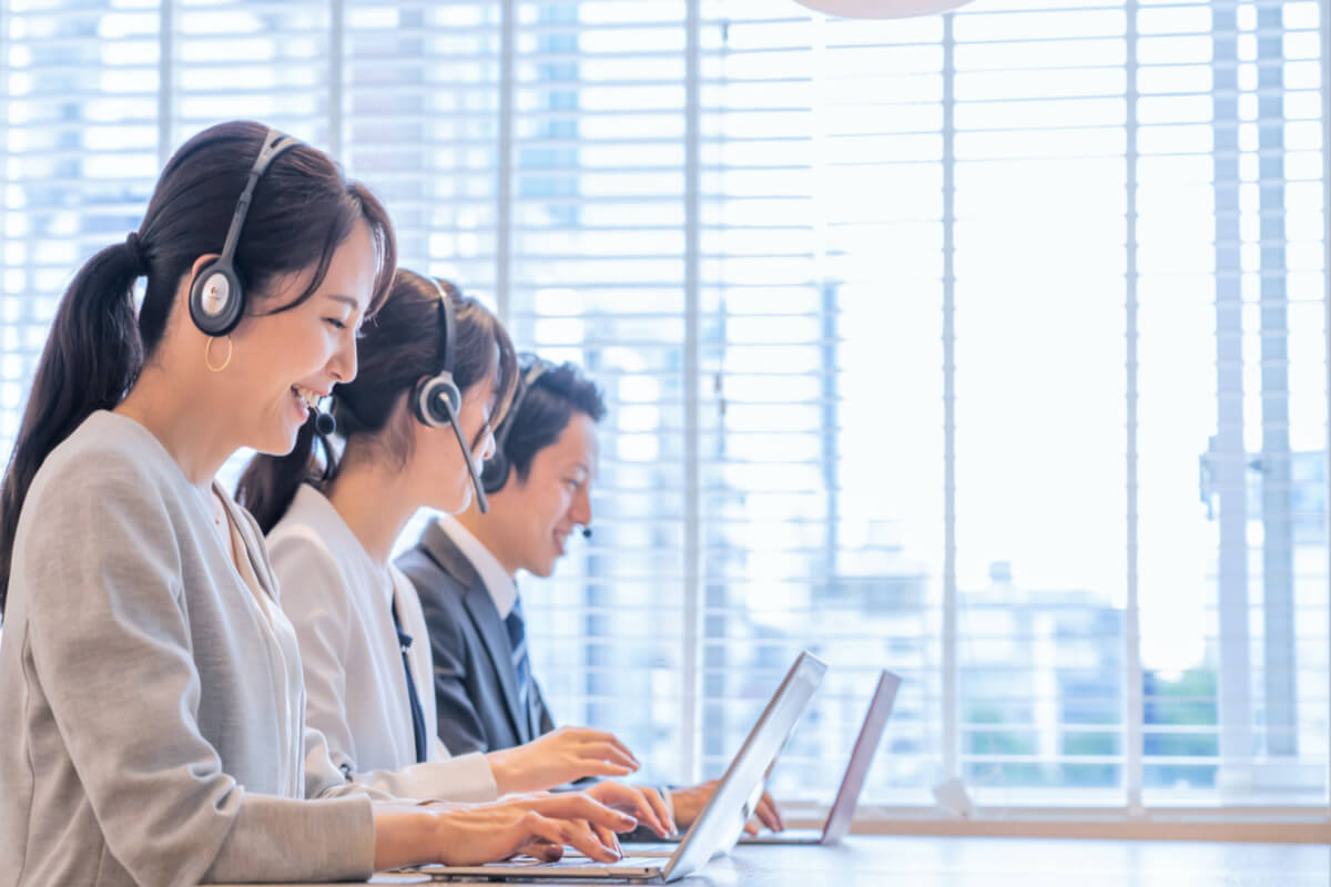 Portrait of Asian men and women wearing headsets