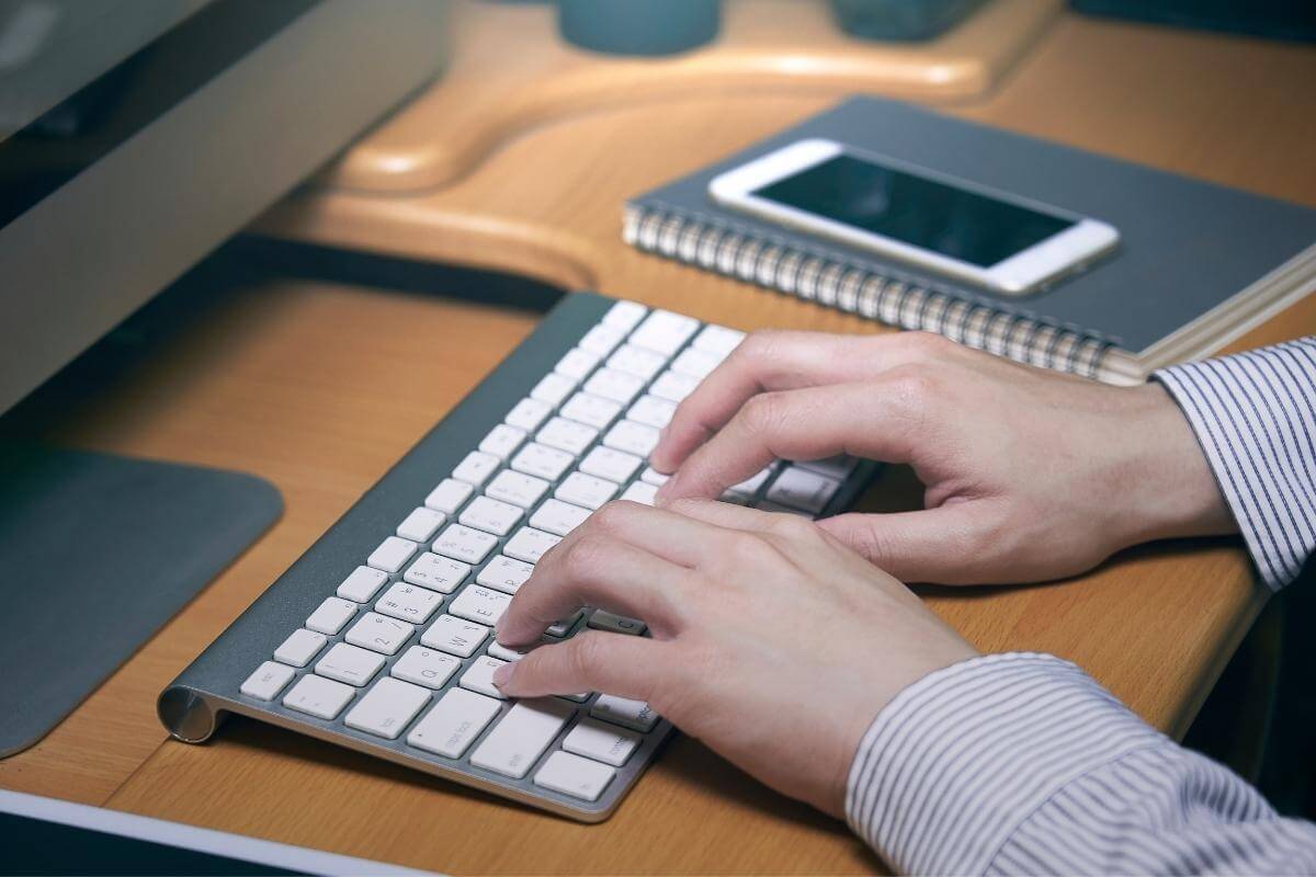 typing keyboard - medical coder working on his computer. 