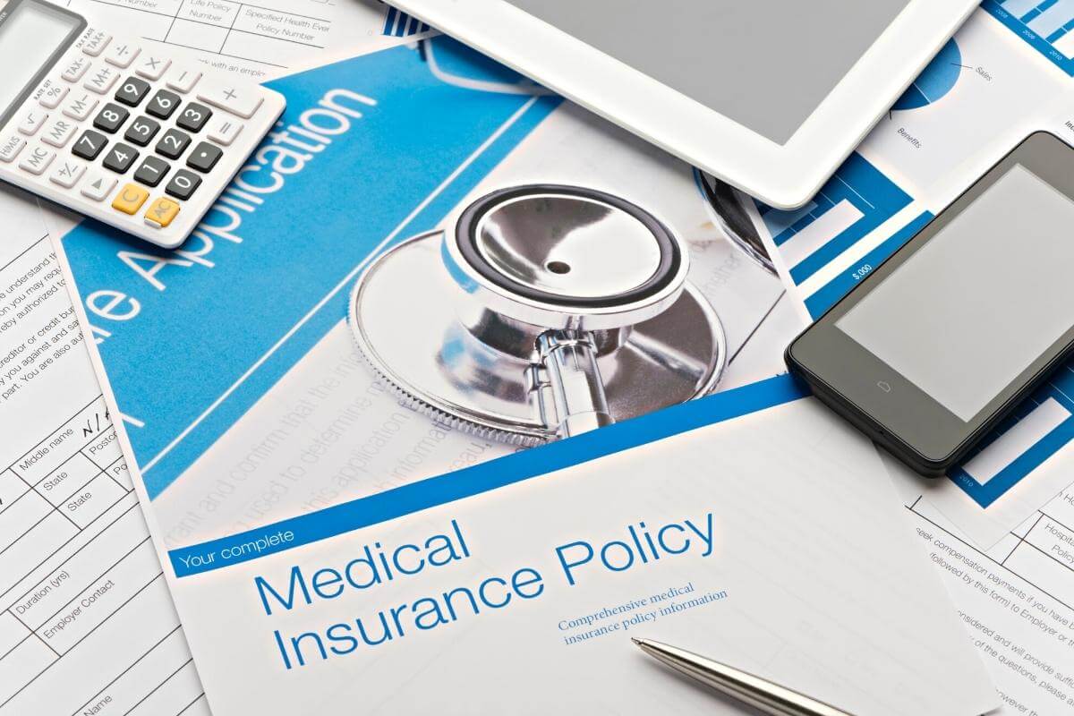 Health insurance policy brochure with paperwork. Medical billing and reimbursement. 