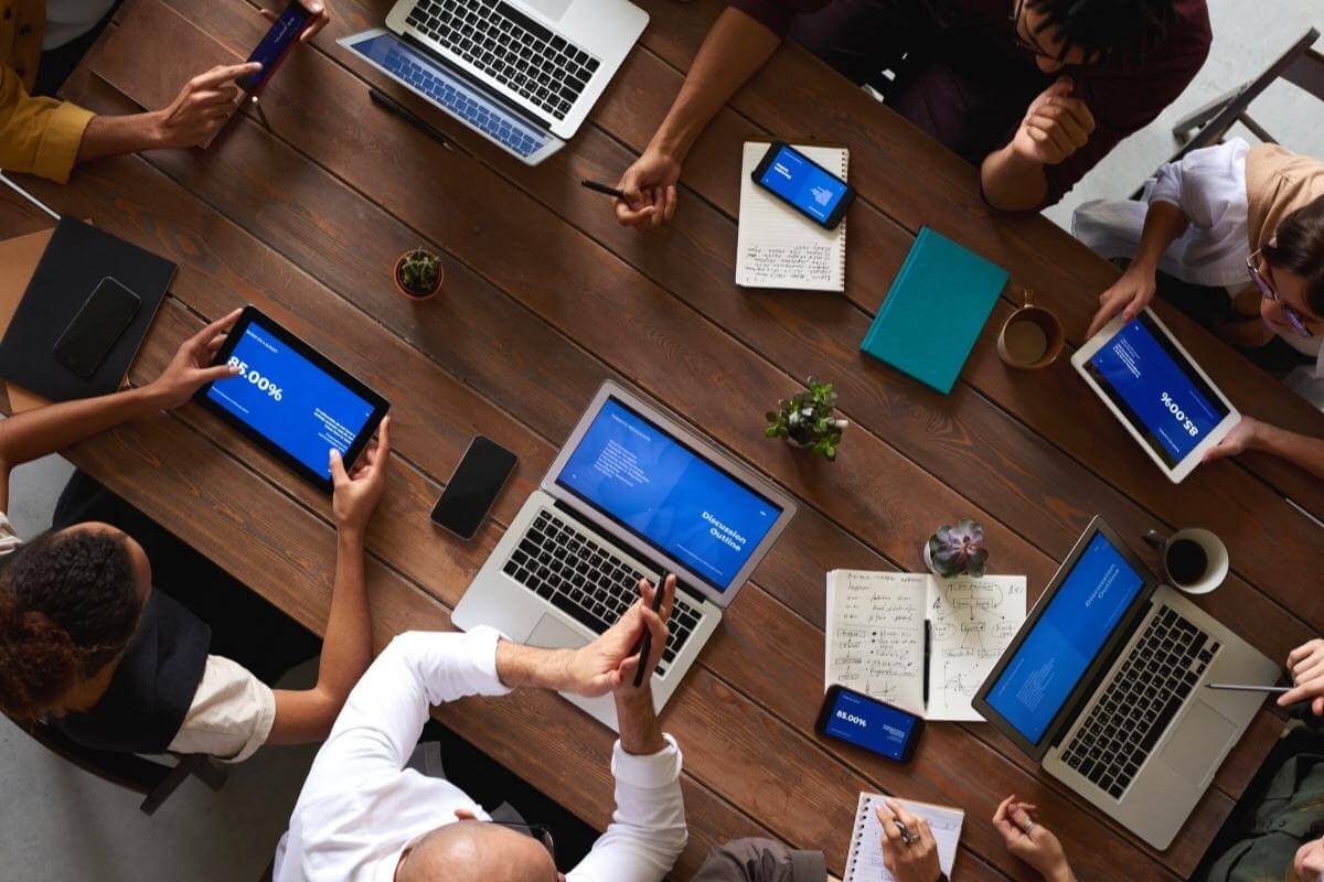 Group of people in a meeting working on their laptops