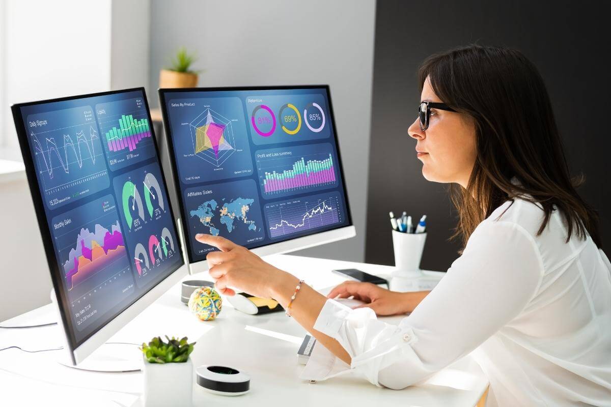 Data Analyst looking at KPI data on a computer screen. 