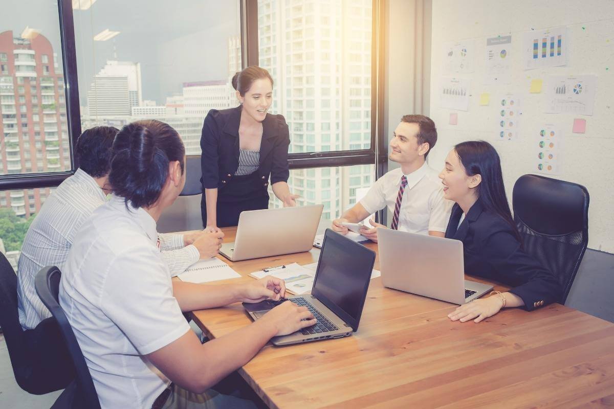 Group of young business team with manager standing leading a team meeting. 