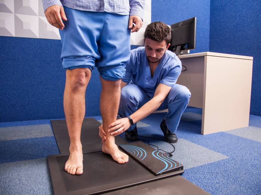 Medical Coding Services and Exceptions for Foot Care - Young man on study of the tread in a podiatry cabinet