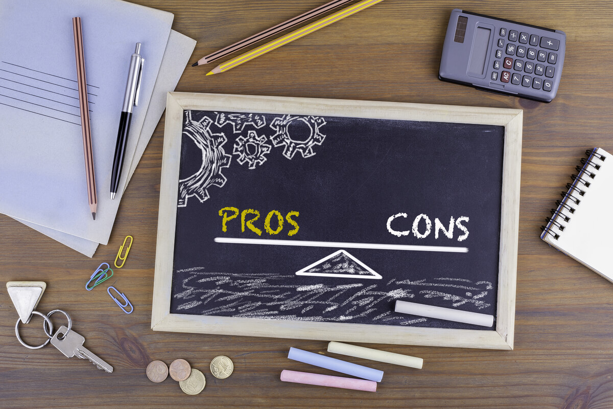 Pros and Cons Balance. Chalkboard on wooden office desk