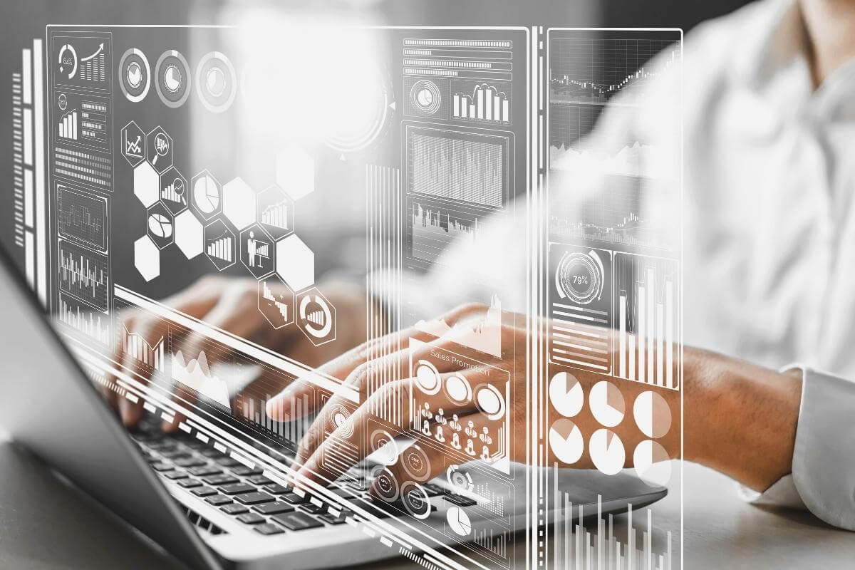 Data analysis for business and finance. Image showing a data analyst working on a laptop with virtual screen reflecting all data.