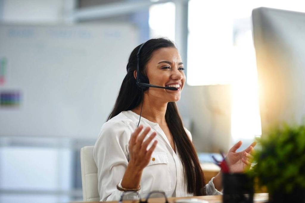 What Is Customer Support Experience - Female customer service agent in a call center aims to give a great customer experience