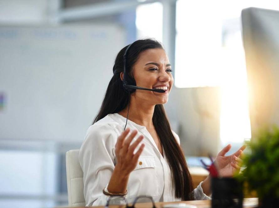 What Is Customer Support Experience - Female customer service agent in a call center aims to give a great customer experience