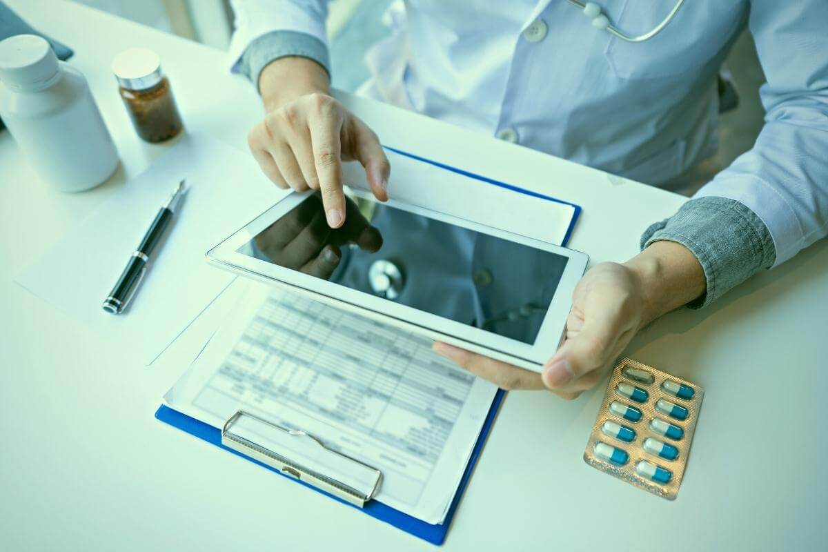 What Is Medical Billing Outsourcing - Dermatologist reading on a document report and writing on paperwork, searching for medical treatment and codes.