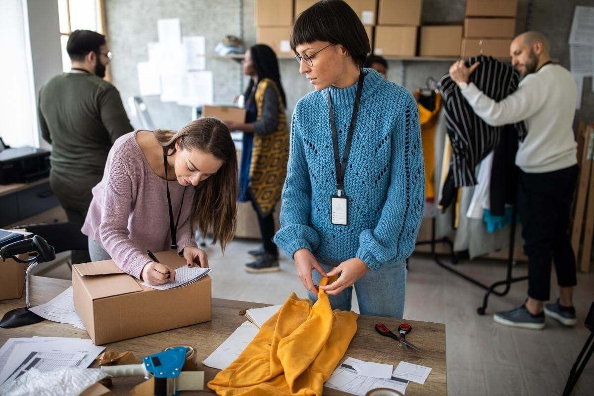 ecommerce business owners busy preparing orders and taking pictures of products