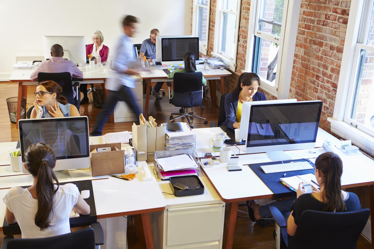 Why Do Companies Outsource Manual Data Entry? - Wide Angle View Of Busy Back Office department With Workers At Desks