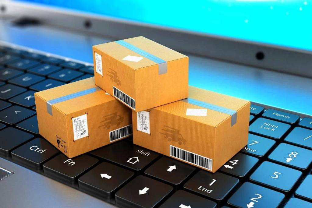 Best Call Center for E-commerce - Shipping, delivery and logistics. Package on top of a laptop keyboard- ecommerce concept