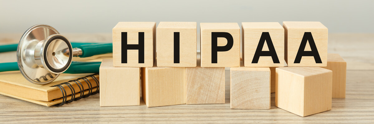 Wooden block form the word HIPAA - The Health Insurance Portability and Accountability Act of 1996. Medical concept.