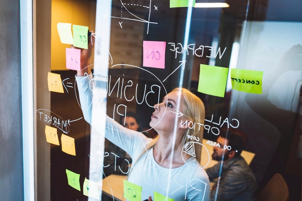 Business Process Outsourcing Company - Young business people in a meeting discussing ideas and business strategy including outs