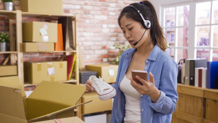 Call Center for Ecommerce - Featured Image_Asian businesswoman owner of SME online answer phone call receive from customer on headset checking product shoes before delivery put in cardboxes. Small start up business customer support operator.
