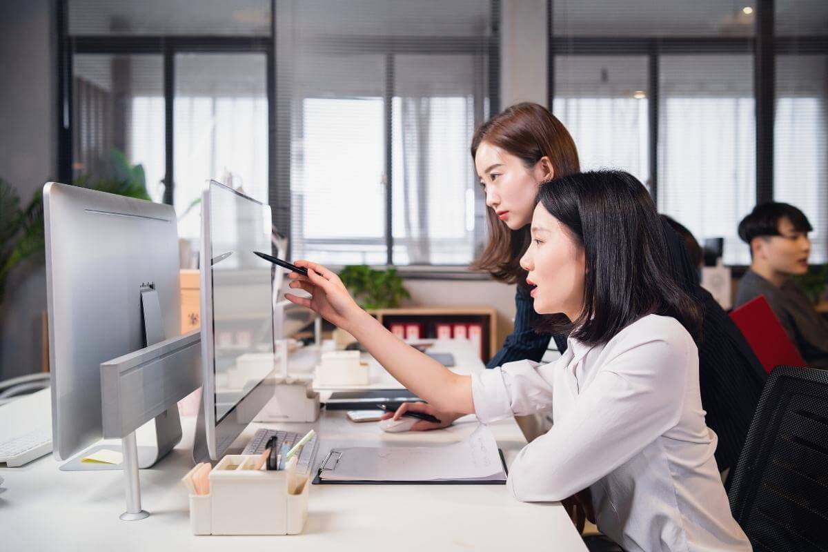 Outsource Bookkeeping Services - Asian bookkeepers working sorting out financial documents