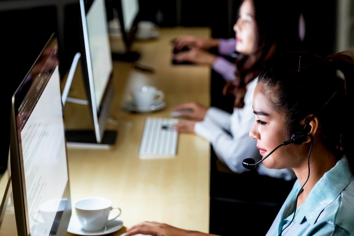 Outsourcing in Ecommerce - Featured Image - Call center agents working in a 24/7 center