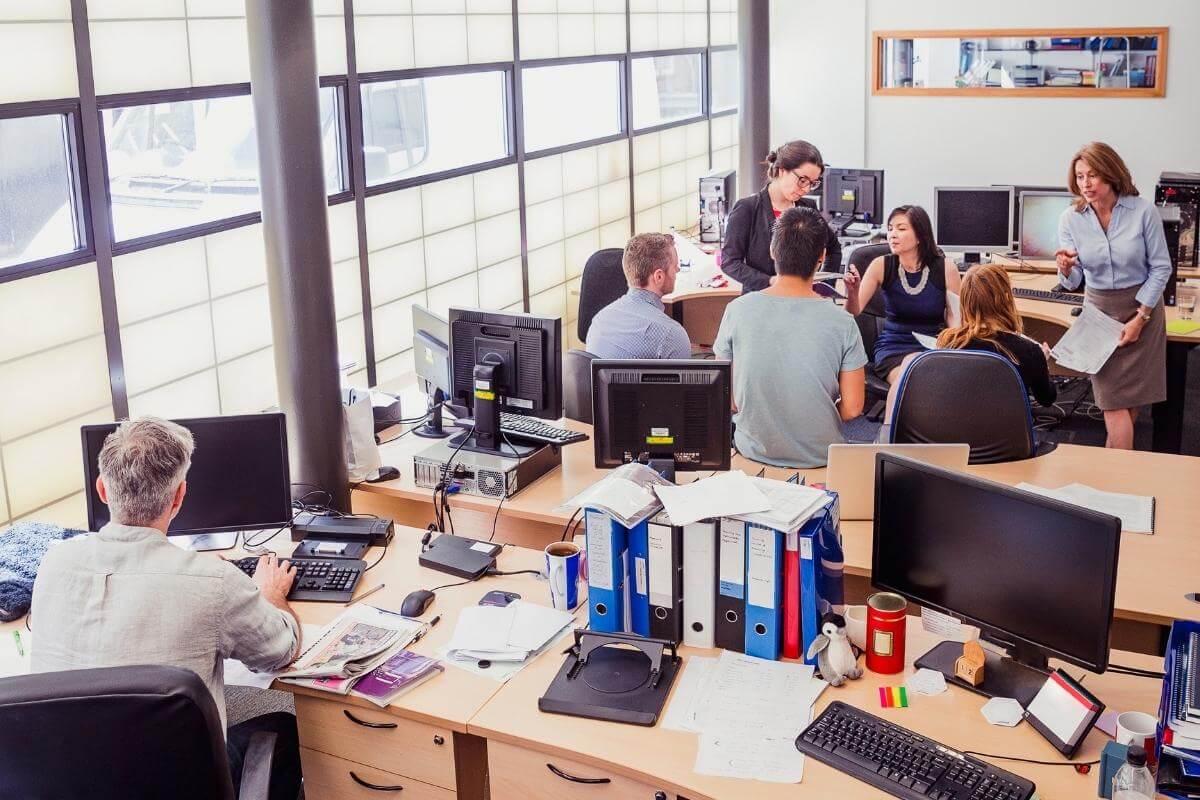 Image of a call center office with busy people working