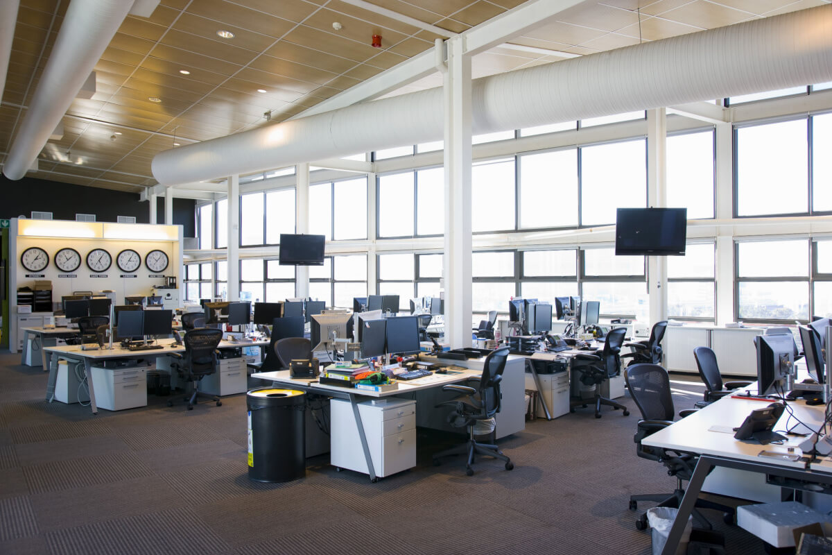 Large view of a call center outside working hours, with time zone clocks.