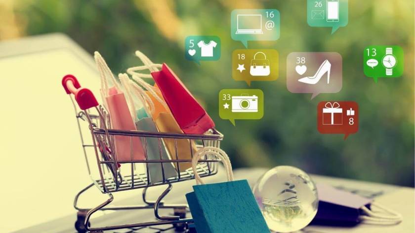 Online shopping e-commerce and customer experience concept, paper shopping bags in a trolley or shopping cart on notebook keyboard.
