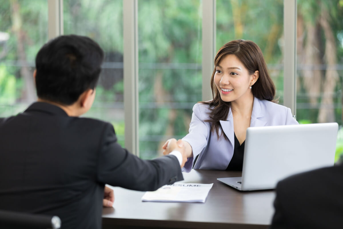 asian business woman shaking hands after a successful job interview at office