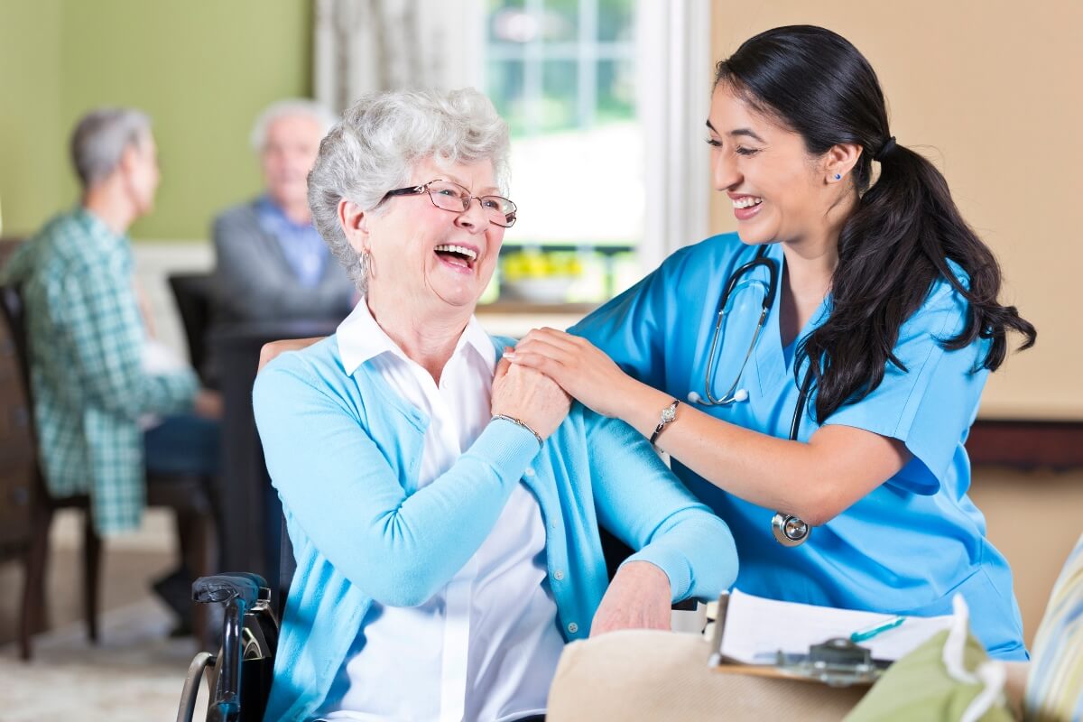 Focus on patient care - Asian nurse with a happy older patient