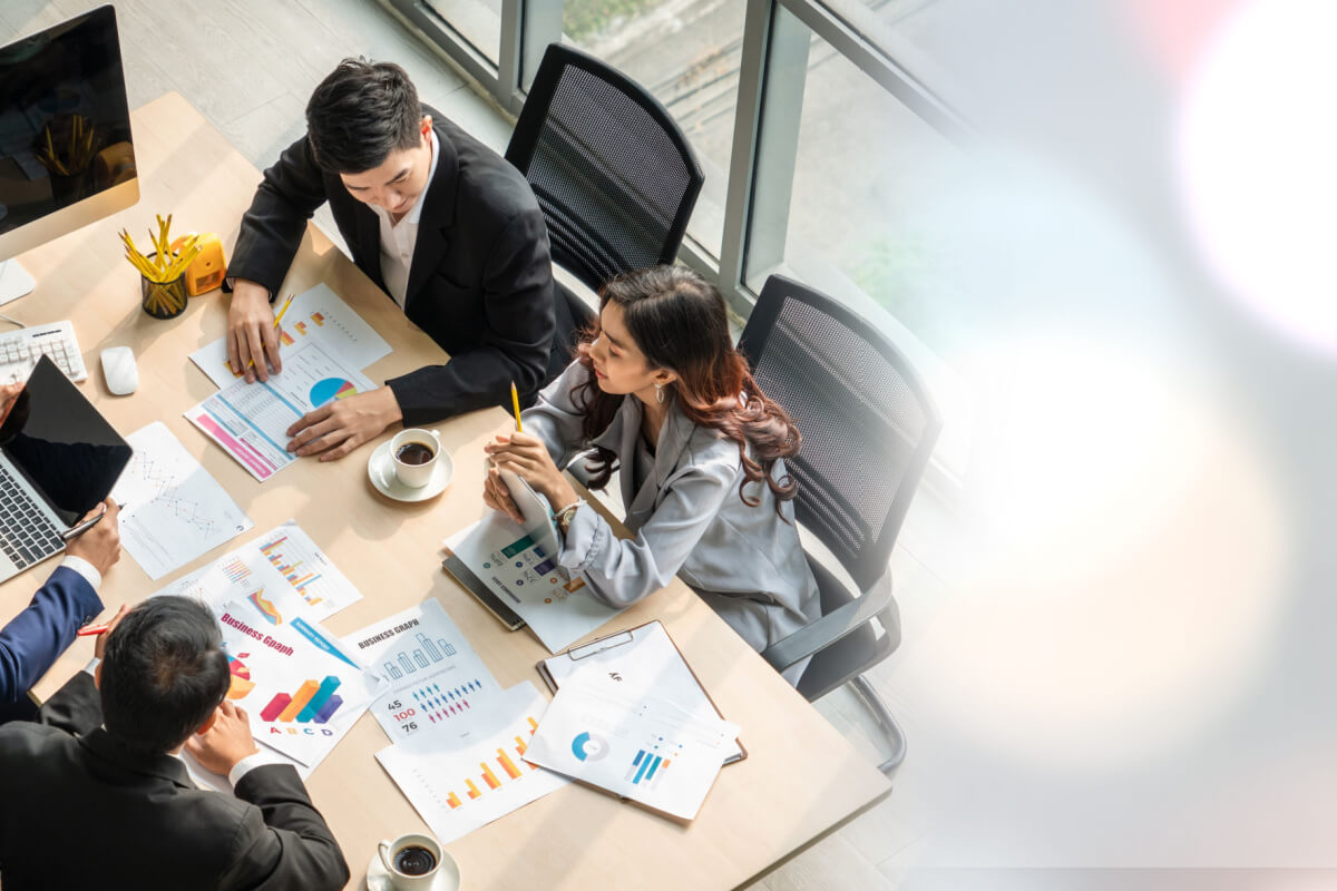 How To Get Started With CCaaS Solutions - Business people group meeting shot from top widen view in office . Profession businesswomen, businessmen and office workers working in team conference with project planning document on meeting