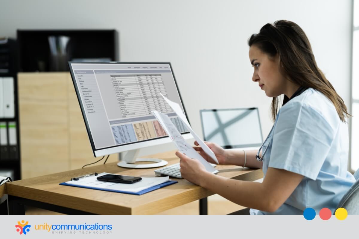 Different Healthcare BPO Services - Medical billing- young Asian nurse reviewing paperwork while looking at a spreadsheet with billing codes