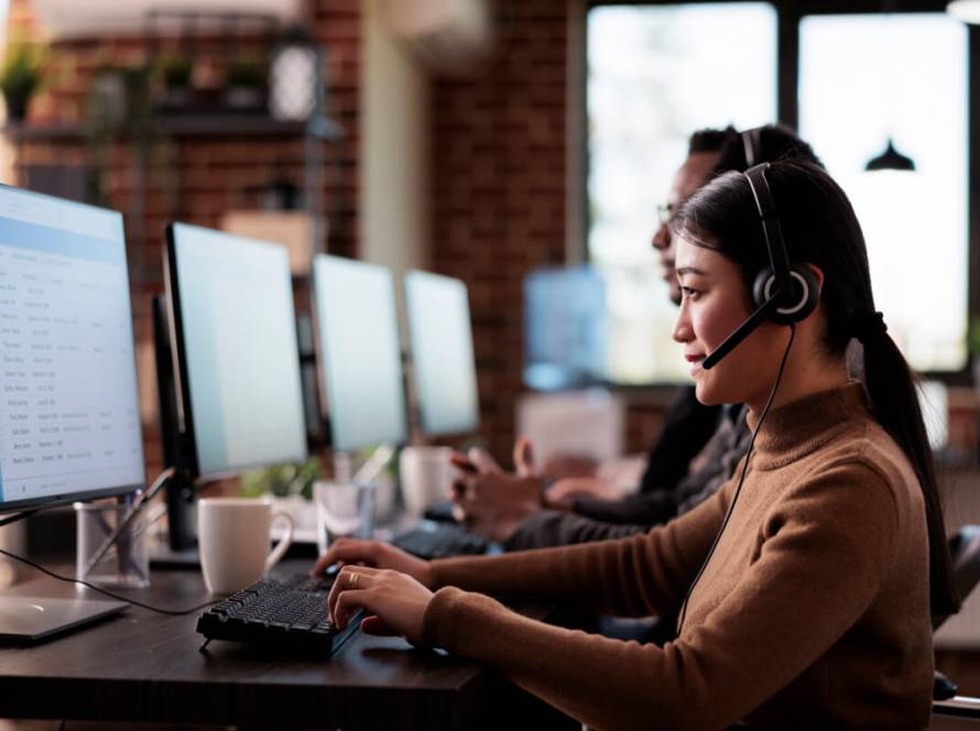 Easy Steps To Outsource Customer Service - Featured Image_Female operator wheelchair user with impairment giving assistance on customer service helpline.