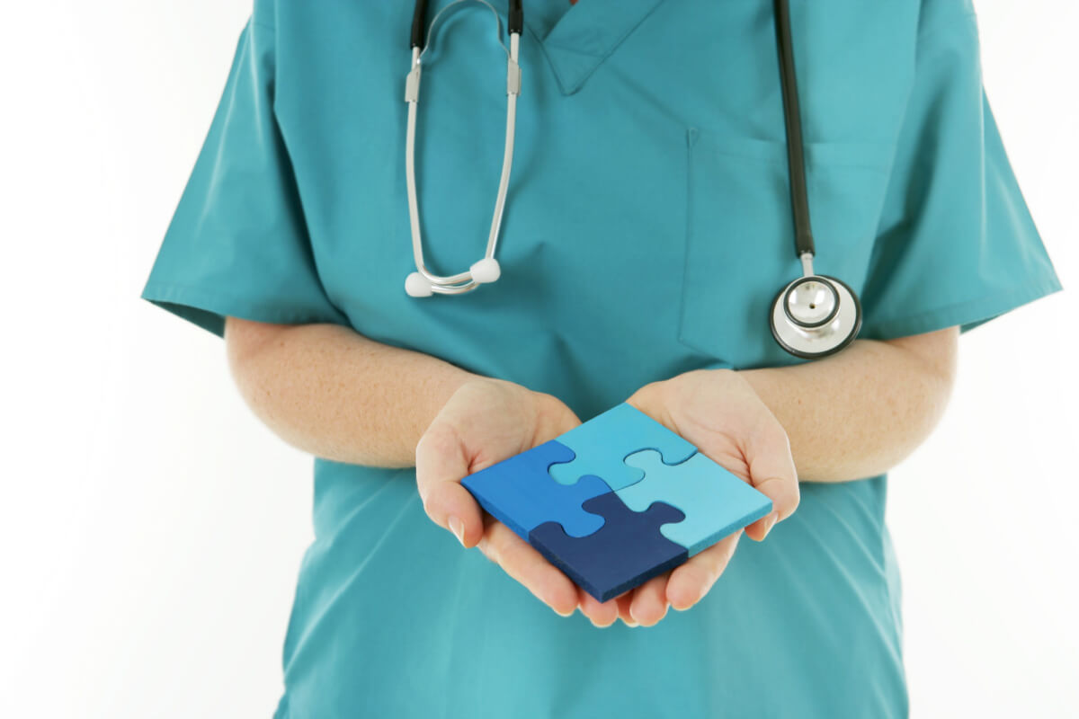 Healthcare Solutions - Nurse holding a completed Jigsaw Puzzle