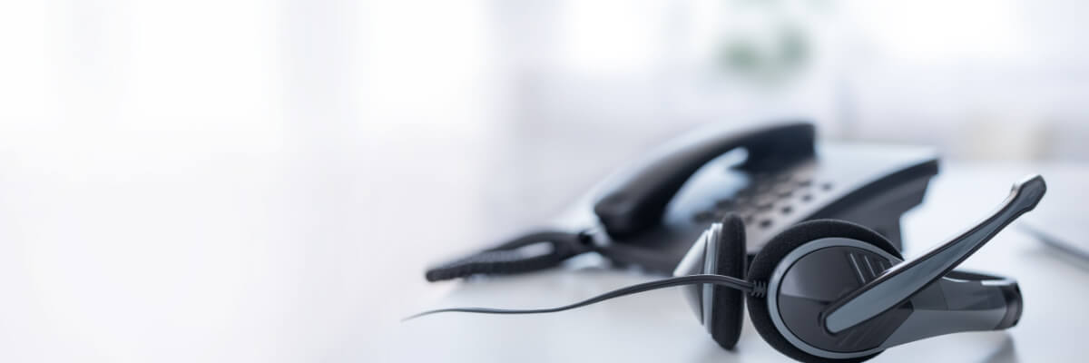 Image of a headset in a call center setup. The telecommunication industry is one who uses BPO services to provide customer support to their clients. 