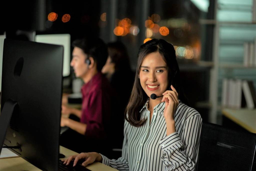 Offshore call center services - featured image_employee customer service representative working as technical support call center in the office with headphone computer overtime in the night